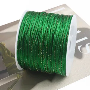 Green metallic cord spooled tightly for DIY crafts, Chinese knotting, and handmade jewelry making.