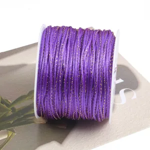 Purple and gold braided cord spool for DIY crafts, jewelry making, and Chinese knotting projects.