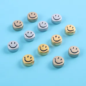 Close-up of metallic gold and silver smiley face acrylic beads for DIY bracelet charms