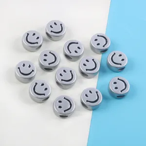 Close-up of metallic silver smiley face acrylic beads for DIY bracelet jewelry making