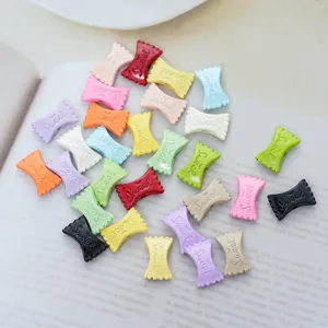 Close-up of colorful candy-shaped macaron alloy charms with Sweet engraving details