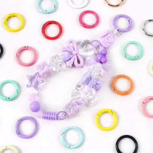 Anillas de resorte de 23mm en colores caramelo para joyería DIY y accesorios de llaveros.