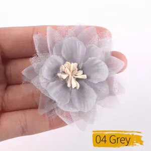 Detailed view of a handmade gray chiffon organza flower for garment accessories.