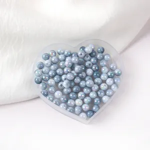 Close-up detail of blue gradient acrylic beads with AB iridescent finish in heart box.