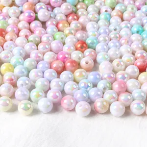 Closeup of colorful AB acrylic round beads, iridescent pastel tone cream beads for DIY crafts.