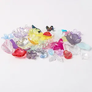 Macro detail of colorful frosted AB acrylic flower petals and leaf beads for DIY craft.