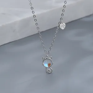 Detailed macro shot of a silver cat pendant necklace featuring a colorful moonstone