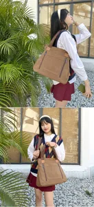 Retro brown canvas tote bag being carried by a model, showing multi-compartment design