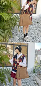 Detail view of a vintage large canvas tote bag with multiple compartments for stylish women.