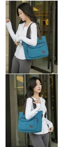 Side view of a blue canvas tote bag on a model, highlighting its large capacity