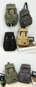 Detailed view of multi-colored canvas backpacks with drawstring and buckle closures.