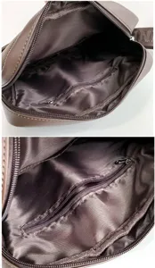 Detail view of the spacious interior and zipper pocket of Oxford fabric messenger bag