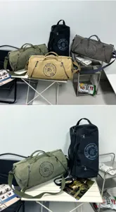 Detailed view of durable canvas duffel bags in various colors for travel and sports