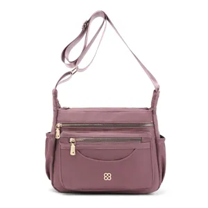 Front view of a purple multi-compartment nylon shoulder bag with adjustable strap