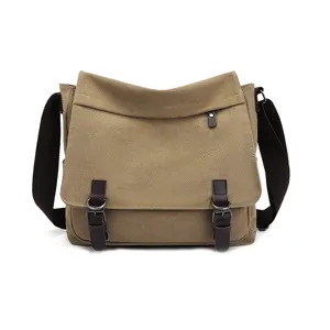 Detailed front view of a khaki canvas messenger bag with brown leather accents and buckles.