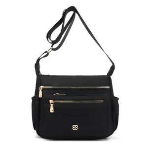 Detailed view of a black multi-pocket crossbody bag featuring elegant gold zippers