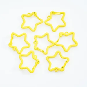 Detailed macro view of seven yellow star-shaped spring lobster clasps for DIY jewelry making