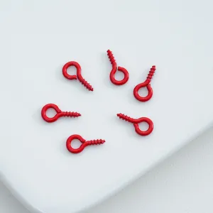 Detail shot of red painted screw eye hooks for DIY phone case pendants and jewelry accessories.