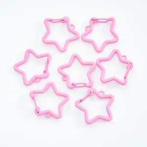 Multiple pink painted star-shaped carabiner clips for DIY jewelry and keychain making