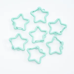 Macro view of mint green star-shaped spring lobster clasps for DIY jewelry crafts.