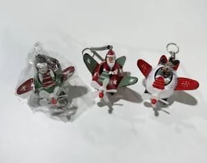 Detailed view of three festive Christmas airplane ornaments in red, green, and white.