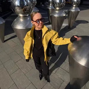 Stylish yellow oversized short jacket for women in a chic outdoor street fashion setting.