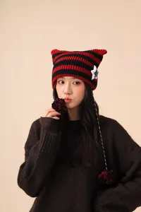 Cute striped cat ear knit beanie with stars and pom poms for a trendy devil look.
