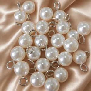 Set of high-gloss ABS pearl pendants with silver hanging rings on satin fabric