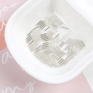 Detailed macro view of 2x7mm silver-lined glass tube beads for DIY jewelry making