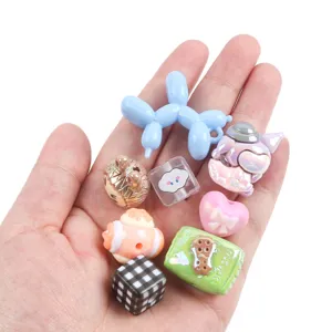 Detailed view of colorful cartoon beads including balloon dog and heart for DIY crafts