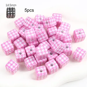 Close-up of pink houndstooth square beads for DIY jewelry and keychain making
