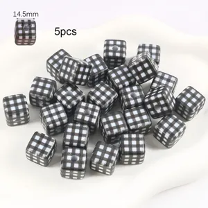Detailed view of 14.5mm black and white checkered square beads with 4mm straight hole