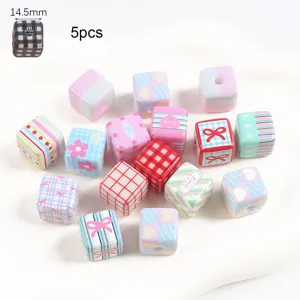 Close-up detail of 14.5mm cute patterned acrylic cube beads for handmade DIY jewelry crafts