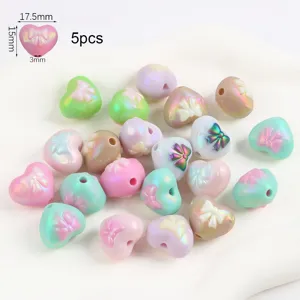 Detailed view of iridescent heart-shaped beads with bow designs and 17.5mm size markings