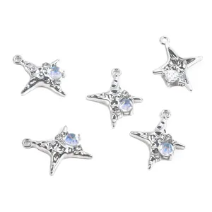 Detail view of silver alloy star charms with iridescent stones for DIY jewelry