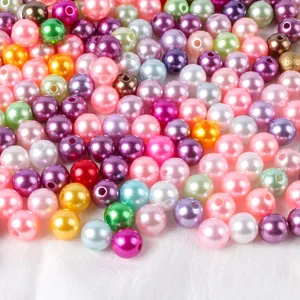 Close-up detail of colorful ABS pearl beads for DIY handmade jewelry bracelets and phone cases.