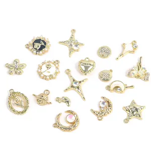 Selection of gold-tone alloy charms for DIY jewelry featuring stars, moons, and roses