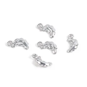 Macro view of five shiny silver dolphin charms featuring sparkling embedded rhinestones for DIY