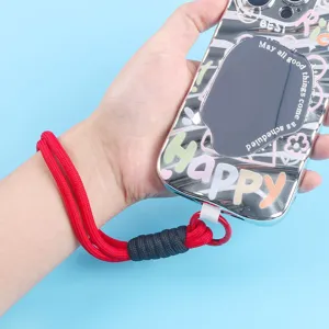 Detail of a 16cm red braided phone wrist strap attached to a mirrored phone case.