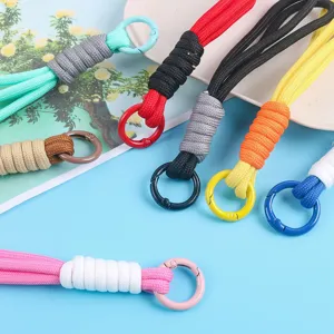 Multi-colored hand-woven phone lanyards and keychains with sturdy metal rings in detail.