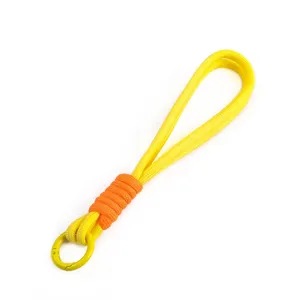 Detail of yellow handmade woven phone lanyard with orange wrap and spring gate ring