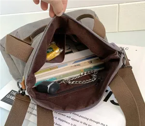 Detail view of the large capacity interior compartments in this vintage canvas tote bag