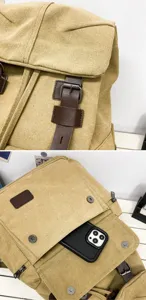 Detail view of khaki canvas backpack featuring leather straps and front pocket storage