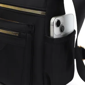 Close-up of black nylon shoulder bag side pocket showing smartphone storage utility