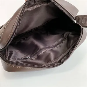 Interior view of brown men's crossbody shoulder bag showing lining and zipper pocket