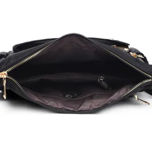 Close-up detail of the multi-compartment interior and metal zippers of a black shoulder bag