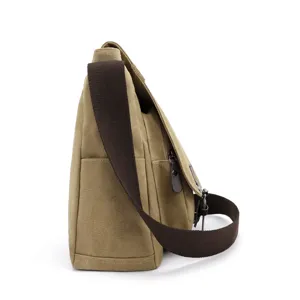 Side view of a khaki canvas messenger bag for men with brown strap