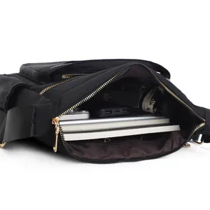 Detailed interior view of a multi-compartment black shoulder bag showing large capacity.