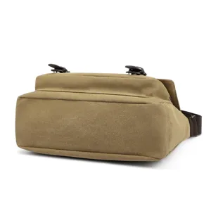 Detailed view of the sturdy bottom and side profile of the khaki canvas bag.