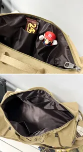 Interior detail view of khaki canvas travel bag showing inner pockets and brown lining